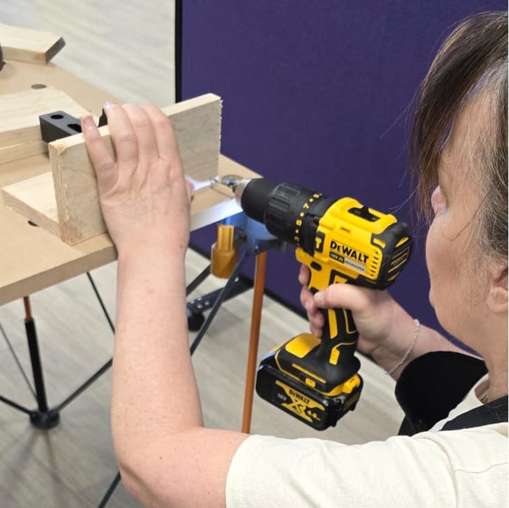 a women using a wood drill in DIY for women class