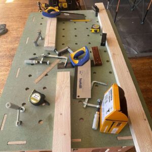 Table-with-wood-cut-offs-and-tools
